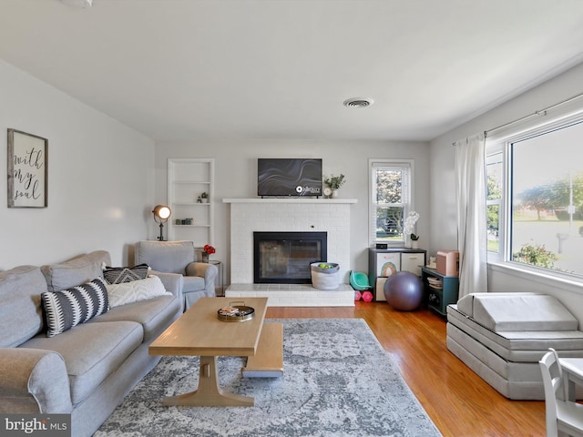 living room featuring a fireplace and hardwood / wood-style floors