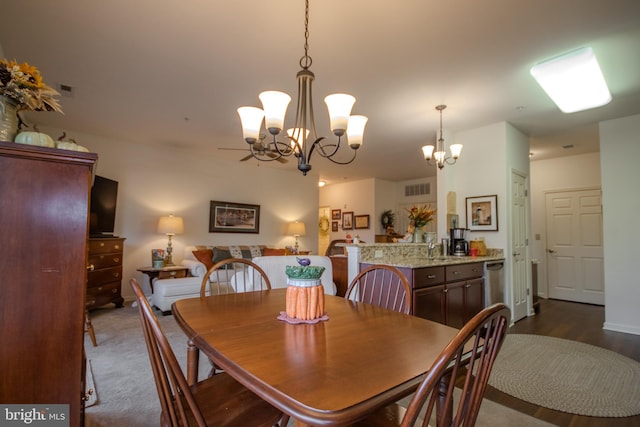 dining space featuring an inviting chandelier and dark wood-type flooring