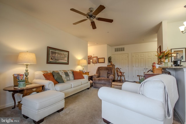 carpeted living room with ceiling fan