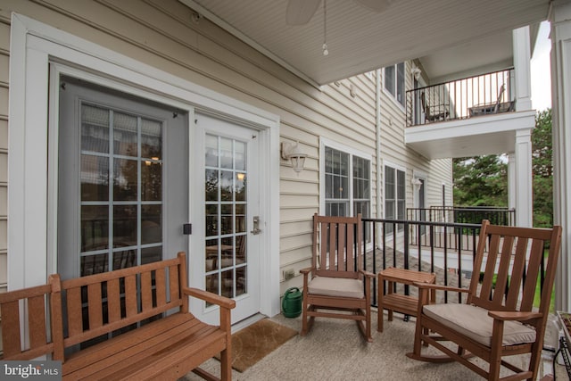 exterior space featuring ceiling fan and a balcony