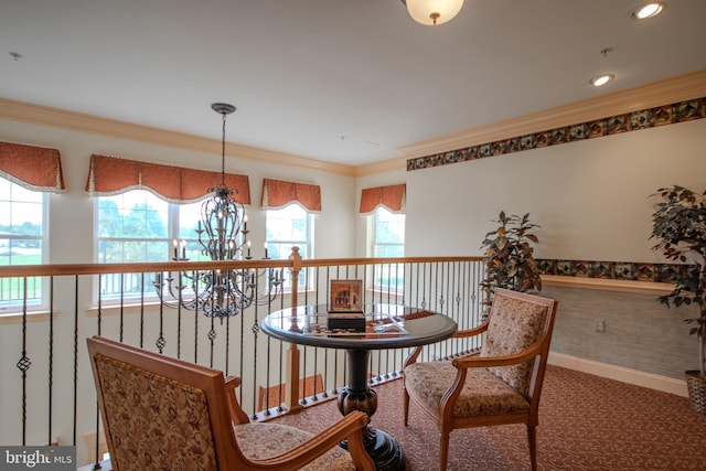 sitting room with carpet, ornamental molding, and a chandelier