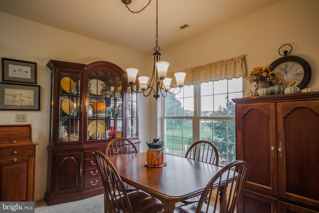 dining area featuring an inviting chandelier