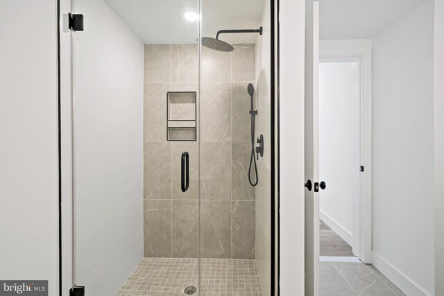 bathroom featuring walk in shower and tile patterned floors