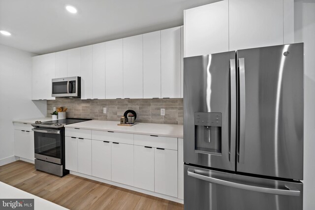 kitchen featuring appliances with stainless steel finishes and white cabinetry