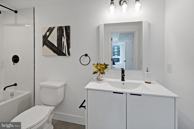 full bathroom with tile patterned flooring, tiled shower / bath combo, vanity, and toilet