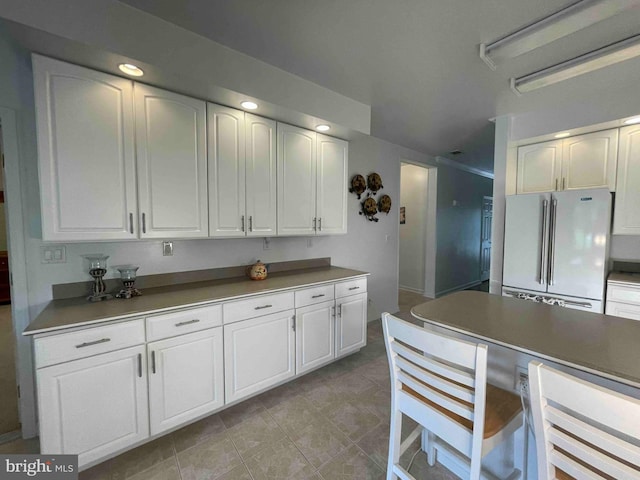 kitchen with white cabinetry and high end fridge