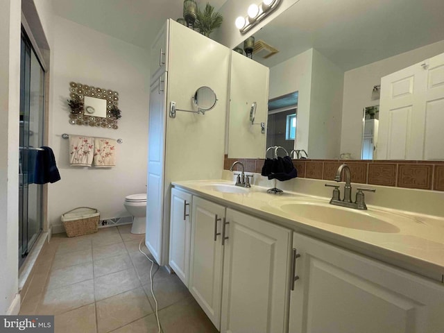 bathroom with tile patterned flooring, walk in shower, vanity, and toilet