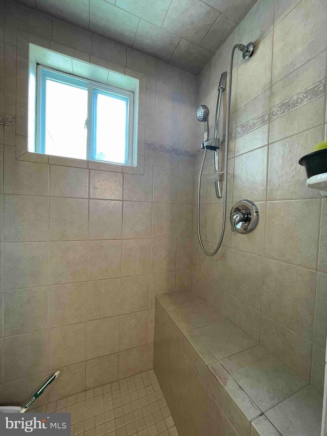 bathroom with a tile shower