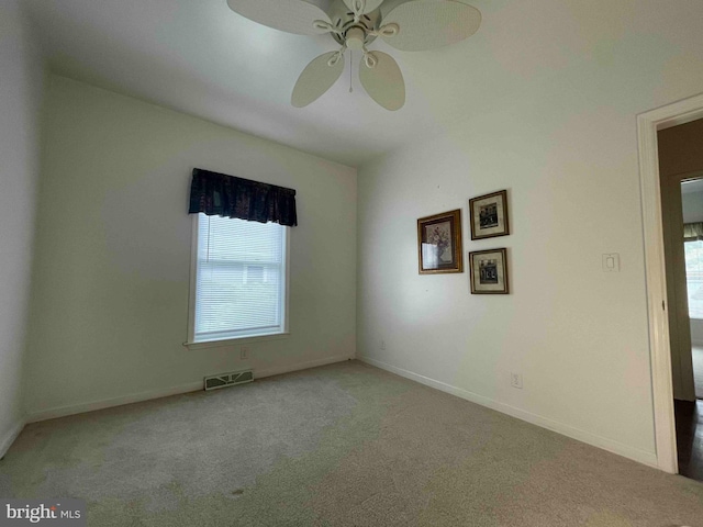 carpeted empty room with ceiling fan