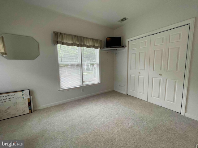 unfurnished bedroom with carpet floors and a closet