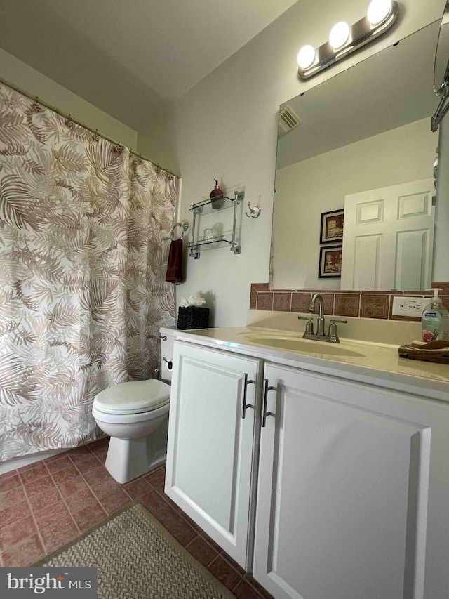 bathroom with vanity, toilet, and tile patterned floors