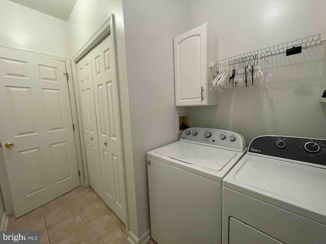 laundry room with cabinets, separate washer and dryer, and light tile patterned flooring