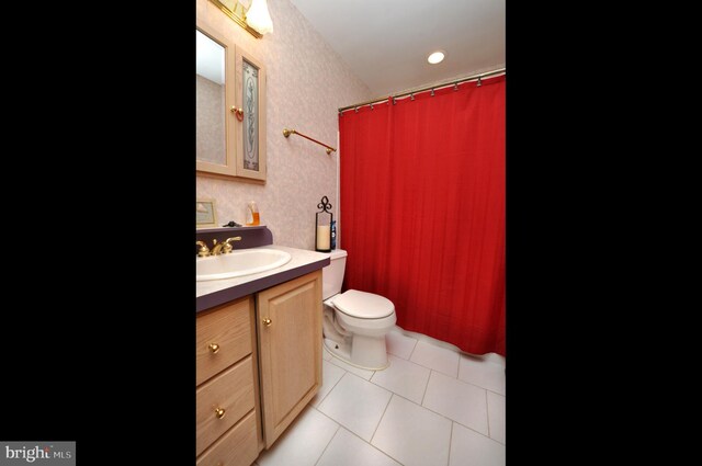 bathroom featuring vanity, toilet, and tile patterned flooring