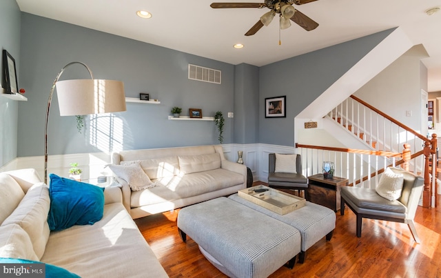 living room featuring ceiling fan and hardwood / wood-style flooring