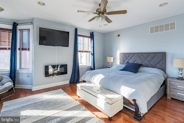 bedroom with hardwood / wood-style floors and ceiling fan