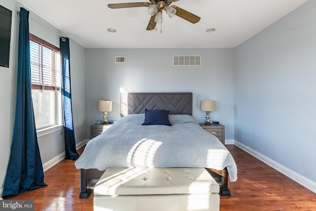 bedroom with ceiling fan and dark wood-type flooring