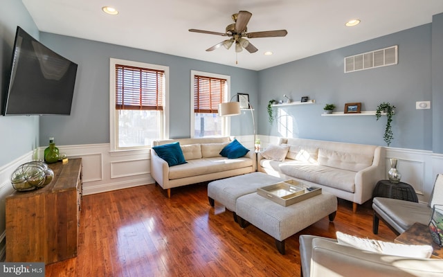 living room with ceiling fan and dark hardwood / wood-style floors