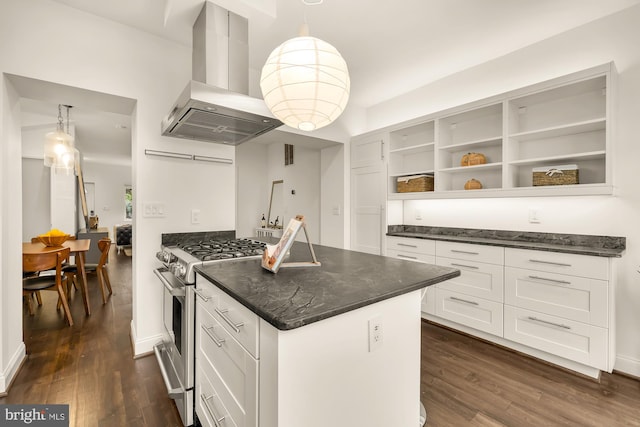 kitchen with island exhaust hood, dark hardwood / wood-style floors, high end stainless steel range, decorative light fixtures, and white cabinets