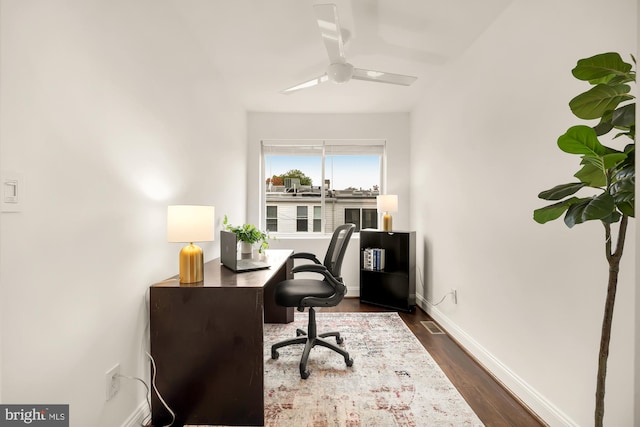 office featuring dark hardwood / wood-style floors and ceiling fan