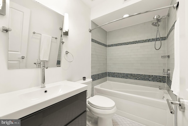 full bathroom featuring vanity, toilet, tile patterned flooring, and tiled shower / bath