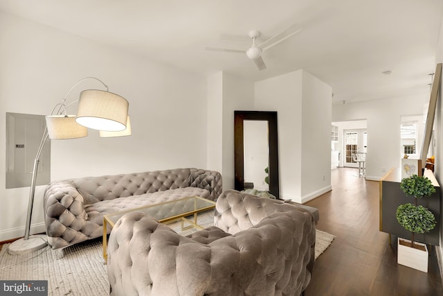 living room with electric panel, dark wood-type flooring, and ceiling fan