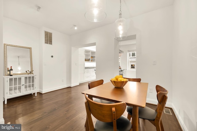 dining area with dark wood-type flooring