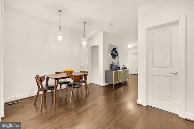 dining space featuring dark wood-type flooring