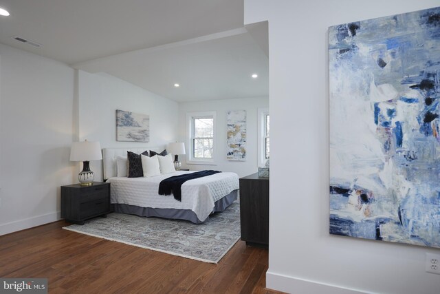 bedroom with dark hardwood / wood-style flooring and vaulted ceiling