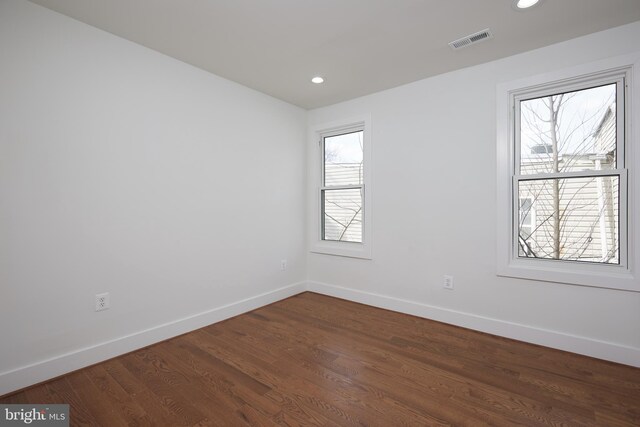 empty room featuring dark hardwood / wood-style flooring