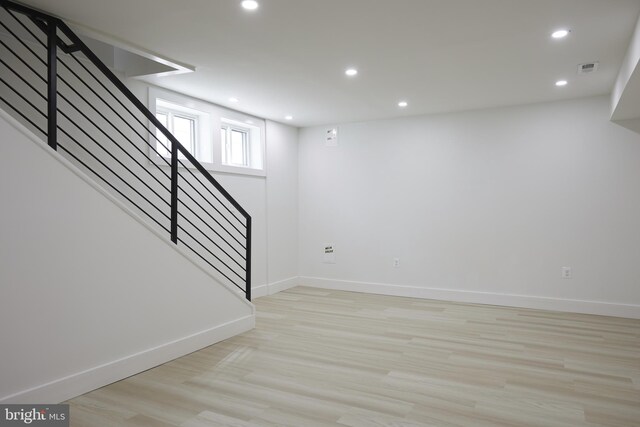 basement featuring light hardwood / wood-style floors