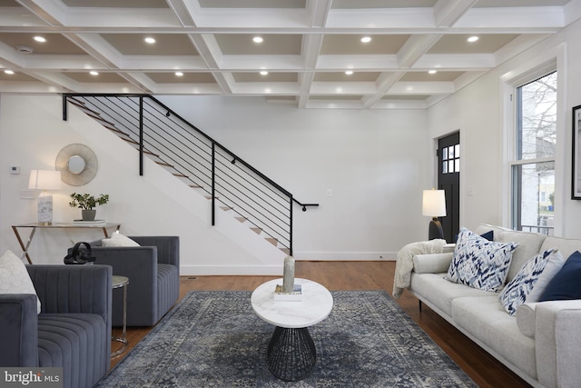 living room featuring beamed ceiling, dark hardwood / wood-style floors, and plenty of natural light