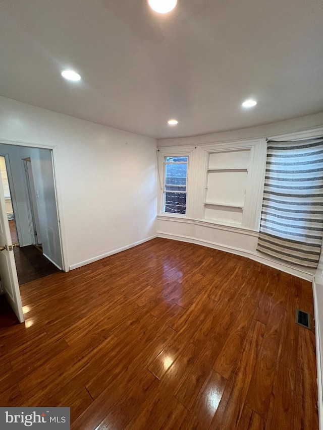 unfurnished living room featuring dark hardwood / wood-style floors