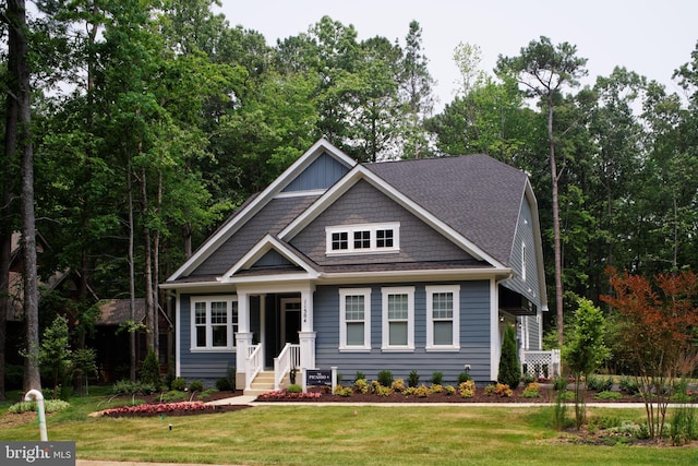 craftsman-style house with a porch and a front lawn