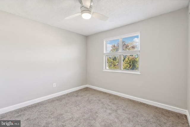 spare room featuring ceiling fan, carpet flooring, and a textured ceiling