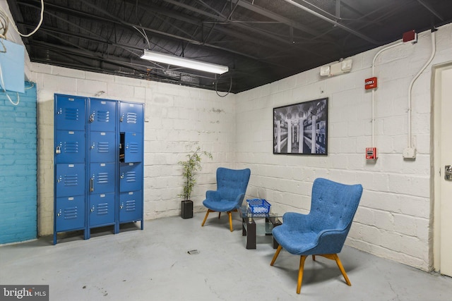 sitting room featuring concrete flooring