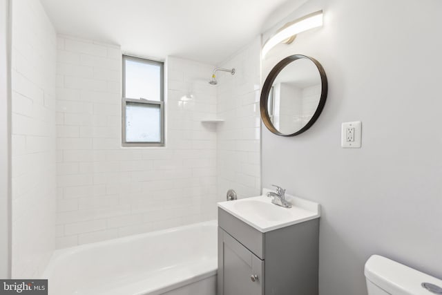 full bathroom with toilet, tiled shower / bath combo, and vanity