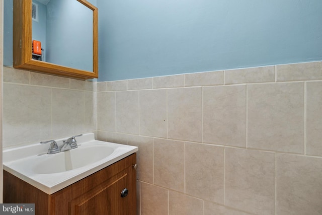 bathroom featuring tile walls and vanity