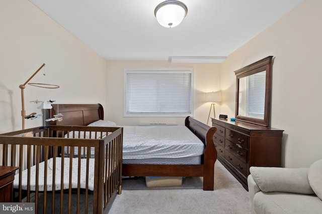 bedroom with multiple windows and light colored carpet