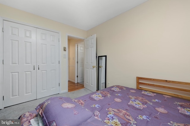 bedroom featuring a closet and light colored carpet