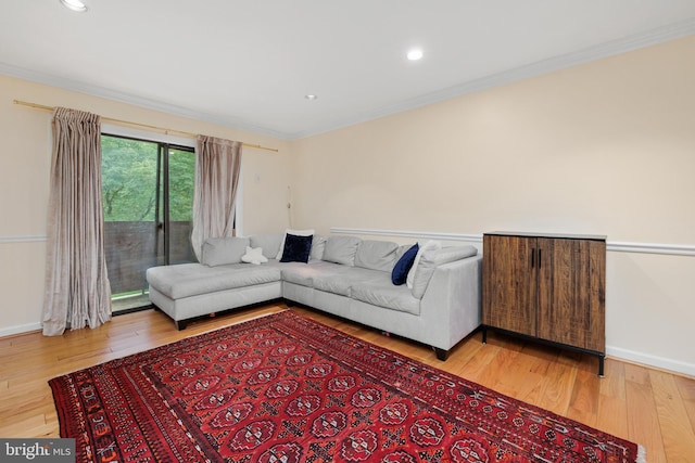 living room featuring ornamental molding and light hardwood / wood-style floors