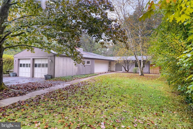 ranch-style home with a garage and a front yard