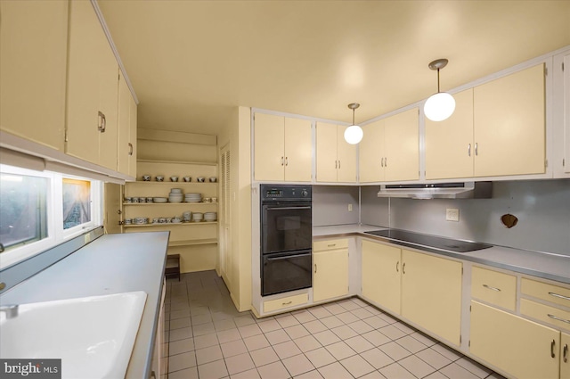 kitchen with black appliances, hanging light fixtures, sink, and light tile patterned floors