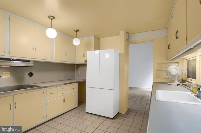 kitchen featuring pendant lighting, white refrigerator, sink, ventilation hood, and light tile patterned floors