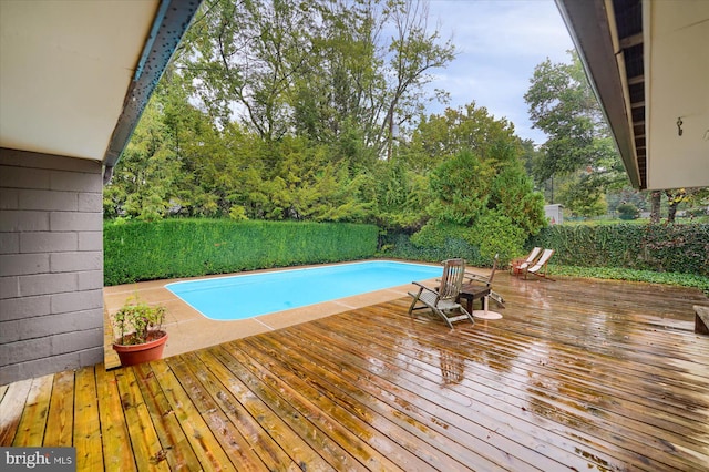 view of swimming pool featuring a wooden deck