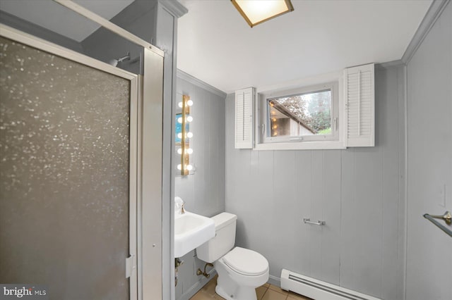 bathroom with baseboard heating, ornamental molding, toilet, sink, and tile patterned floors