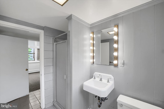 bathroom with sink, tile patterned floors, walk in shower, crown molding, and toilet