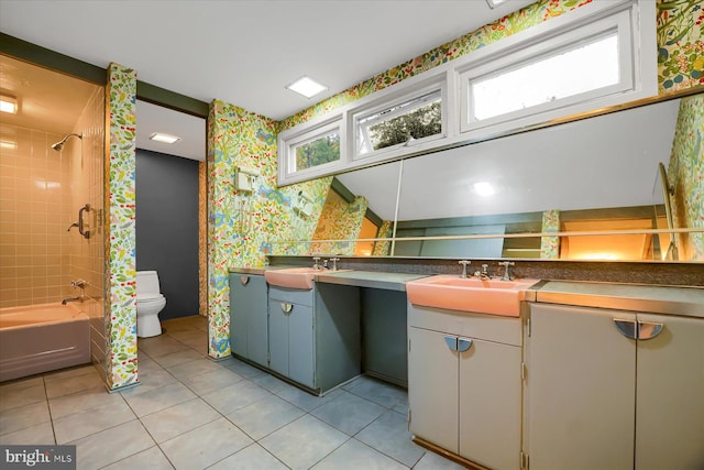 full bathroom featuring tile patterned floors, tiled shower / bath combo, vanity, and toilet