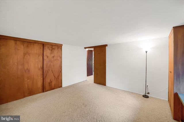 unfurnished room with light colored carpet