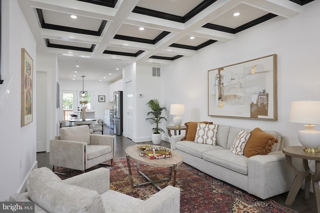 living room featuring beam ceiling, coffered ceiling, hardwood / wood-style flooring, and crown molding