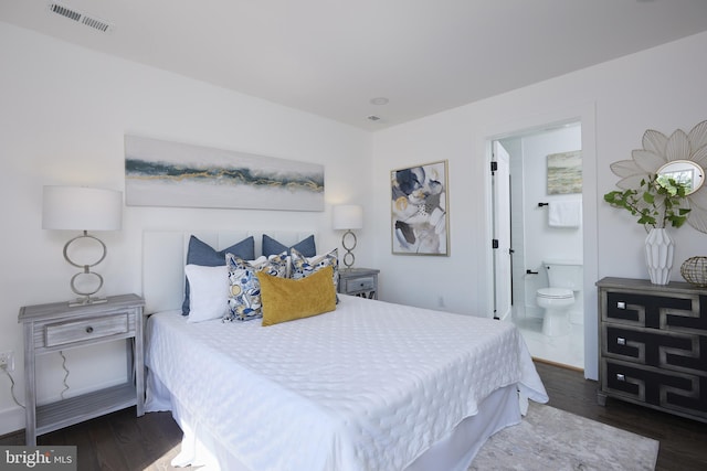 bedroom with ensuite bath and dark hardwood / wood-style flooring